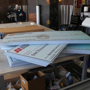 Giant Checks on Coroplast